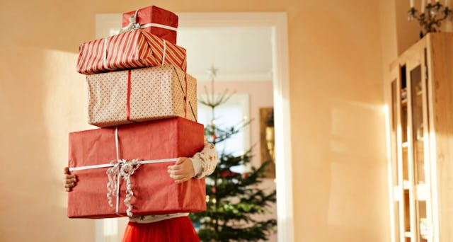 A person carrying gifts, implementing the 4-gift rule while walking through a hallway