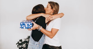 Mom hugging her daughter during the holiday gift exchange