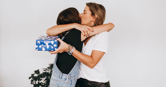 Mom hugging her daughter during the holiday gift exchange