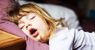 Little Girl Sleeping Soundly With Her Mouth Open with a white noise machine