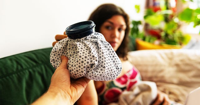 A man giving an ice bag to his wife who wants to improve her sleep