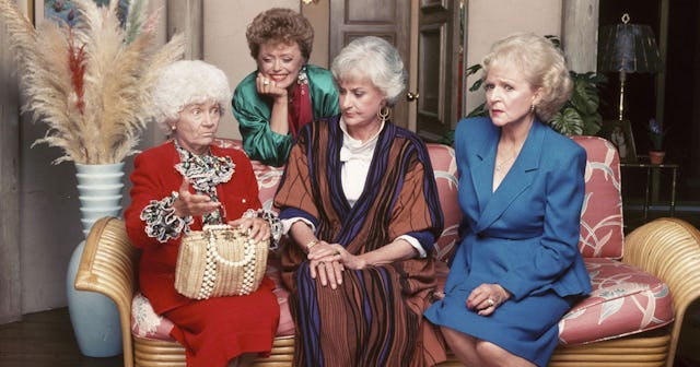 "The Golden Girls" cast sitting on a sofa, laughing, and discussing something.
