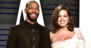 Ashley Graham And Justin ErvIn, both smiling on the red carpet, have welcomed their twin boys
