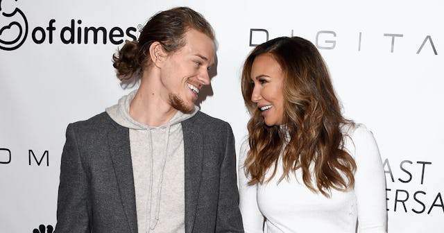 Ryan Dorsey and Naya Rivera on a red carpet, looking at each other and smiling.