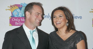 Mariska Hargitay is smiling with Christopher Meloni at an event.