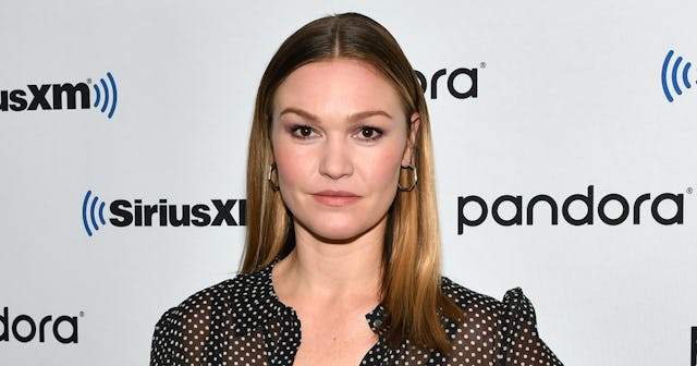 Julia Stiles at a red carpet in a sheer black blouse with white polka dots