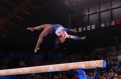 Simone Biles performs a beam routine at the Tokyo Olympics.