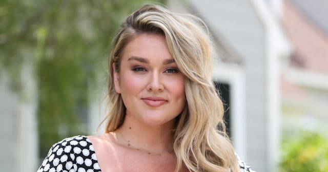 Hunter McGrady wearing a black dress with white polka dots and smiling