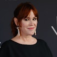 Molly Ringwald smiling at the event in front of the black background who's mom forgot her birthday I...