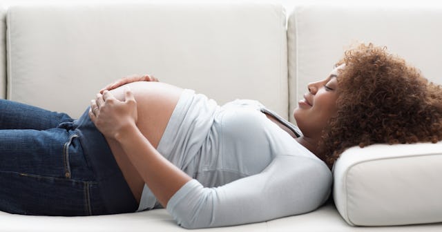 pregnant woman lying on a couch
