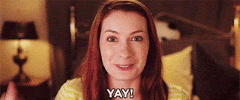Gif of actress Felicia Day wearing a yellow shirt and being cheerful with a caption of her saying "Y...