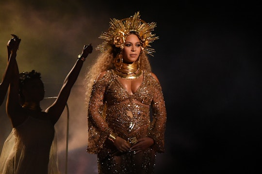 Pregnant Beyonce in a golden sequin dress and golden crown at the 2017 Grammy Awards