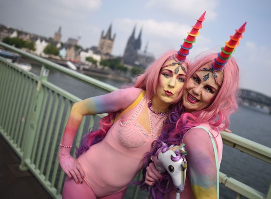 Two girls posing in pink unicorn Halloween costumes