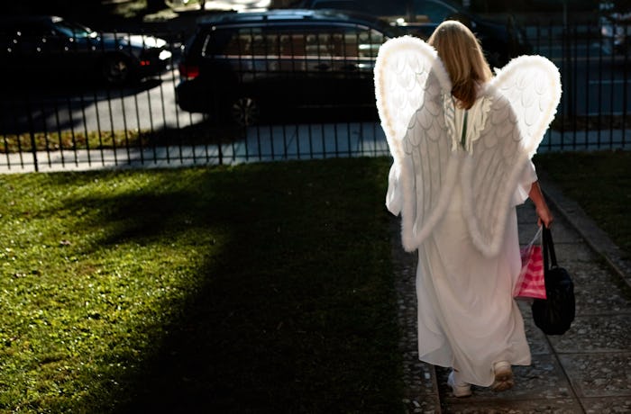 Kid in an angel costume trick or treating in phoenix on halloween