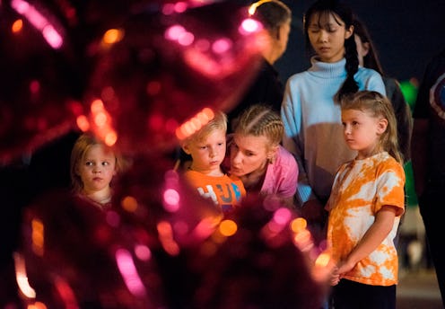 A mother comforting her kids after the traumatic mass shooting.