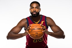 Tristan Thompson posing while holding a Spalding basketball
