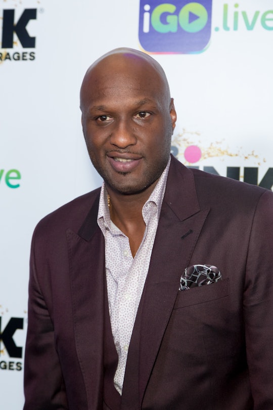 Lamar Odom wearing a suit at a red carpet event