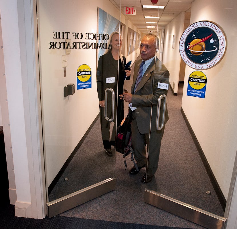 Charles F. Bolden, Jr. enters the NASA Administrator's office with his assistant 