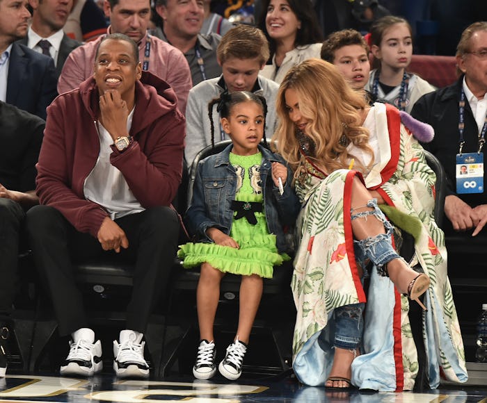 Beyoncé and Jay Z with Blue Ivy courtside at a basketball game 