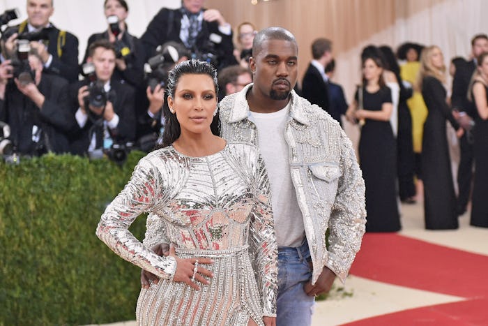 Kim Kardashian in a silver Balmain dress with Kanye West at the Met Gala