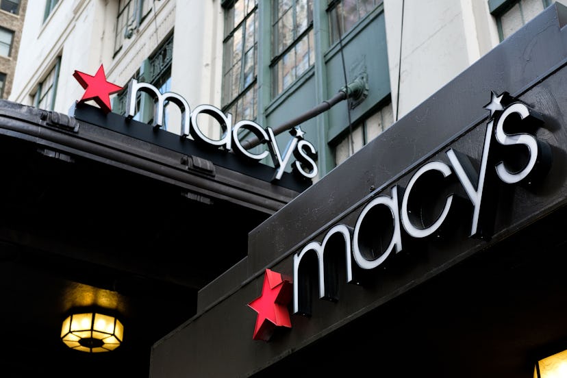 Two Macy's brand signs on a black building.