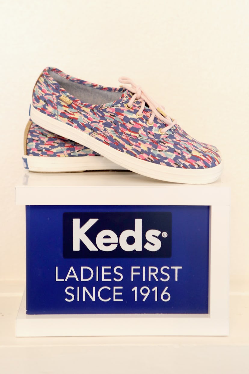 Colorful Keds sneakers laid out on a box with the print saying "Keds, Ladies first since 1916."