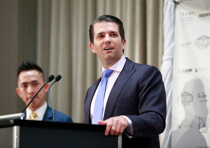 Donald Trump Jr. speaking at a podium into a microphone