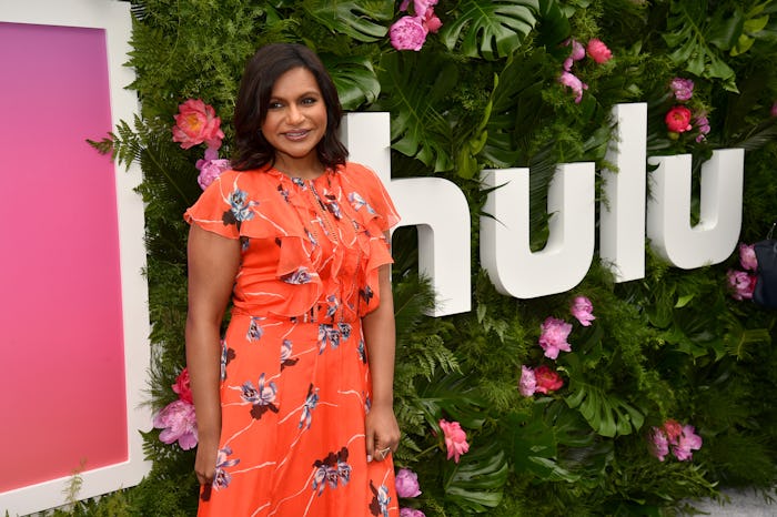 Mindy Kaling wearing an orange floral-patterned dress at the HULU premiere.