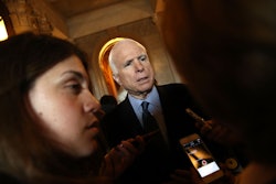 John McCain during an interview in a formal suit