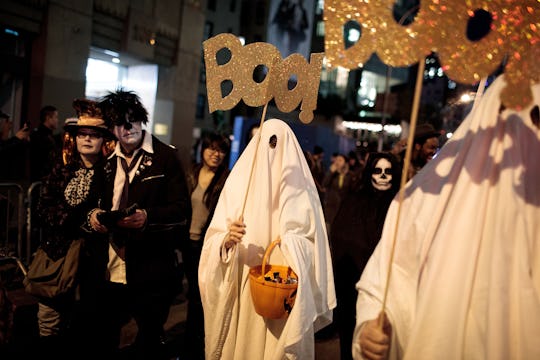 A crowd of trick-or-treaters outside on Halloween night