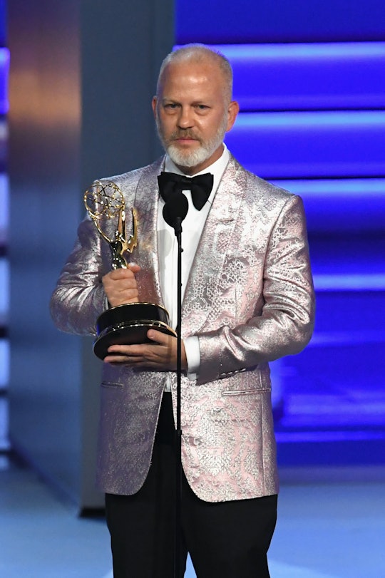 Ryan Murphy holding his Emmy Awards trophy