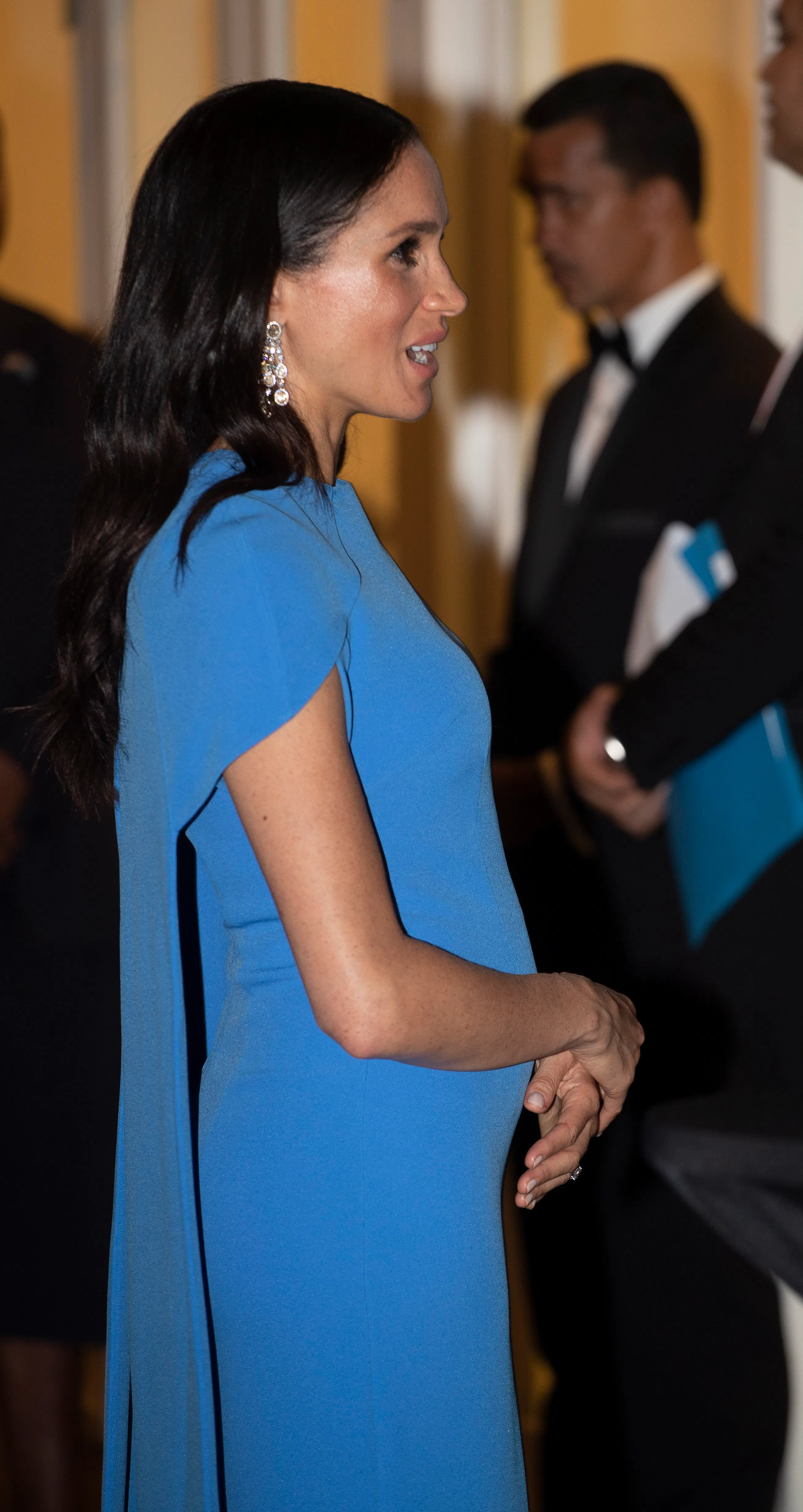 Meghan Markle & Her Growing Bump Look Absolutely Stunning In This Blue Gown (With A Cape!)