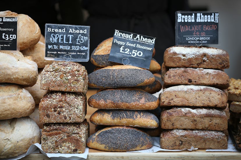 Bakery display full of different types of bread such as almond, poppy seed, and spelt bread.
