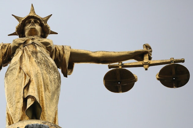 A closer shot depicting the upper part of the Statue of Justice on the Old Bailey in London.