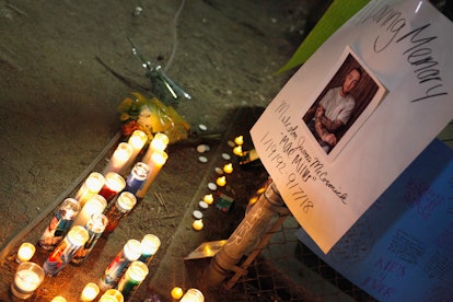 Candles and a poster on a memorial site for the late artist Mac Miller
