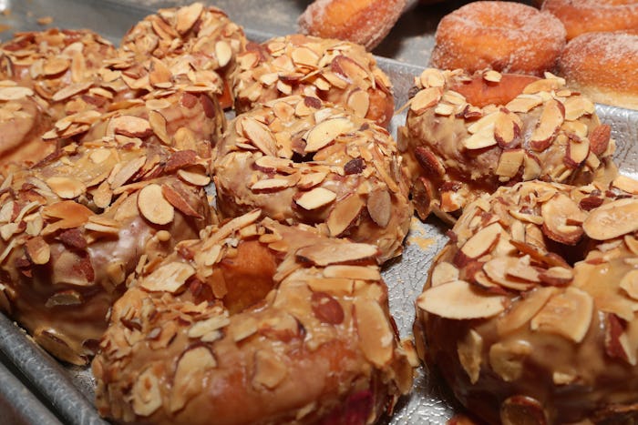 A bunch bagels covered with nuts