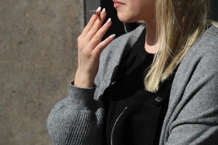 Young blonde lady smoking a cigarette