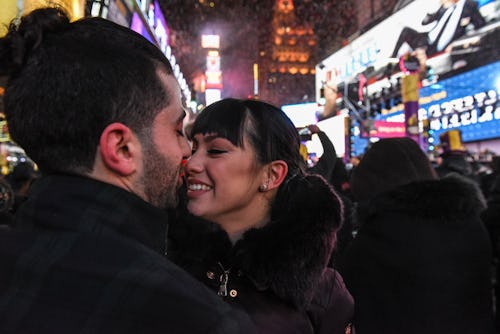 couple about to kiss at midnight on new year's eve