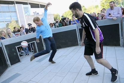 Prince Harry playing football. 