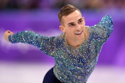 The dazzling Olympic Figure Skater Adam Rippon, skating in black leggings and a blue rhinestone top