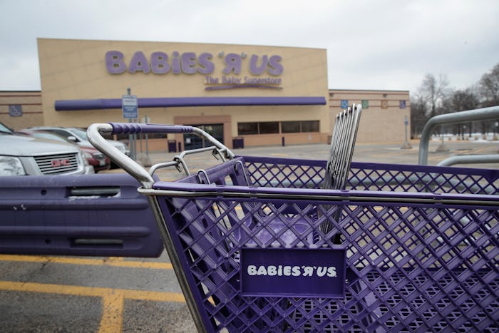 A shopping trolley in the parking lot of a Babies "R" Us