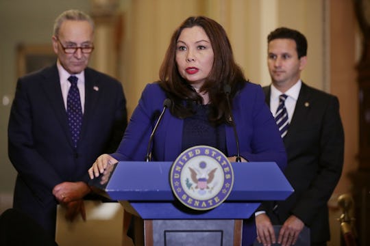 Sen. Tammy Duckworth in front of a podium giving a speech.