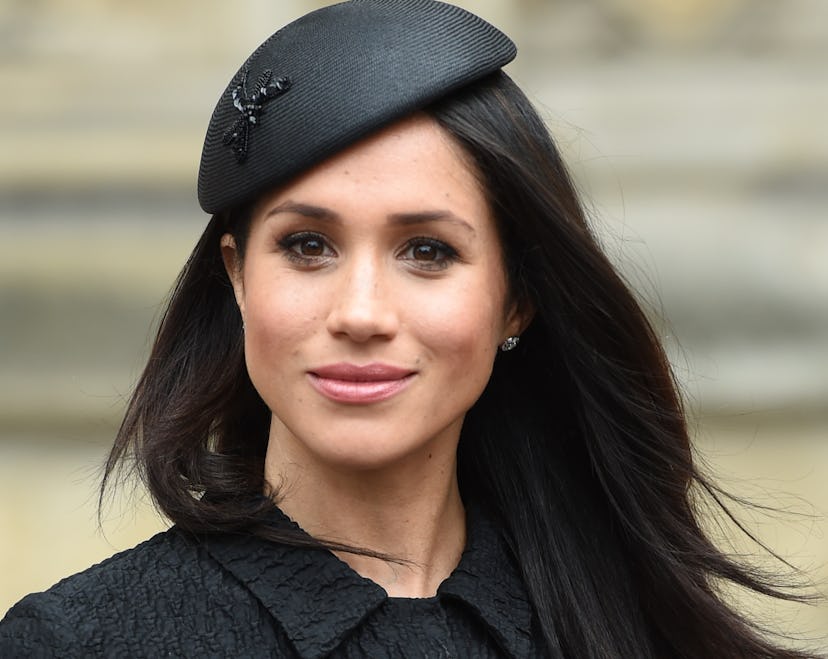 Meghan Markle in the black dress with a black hat 