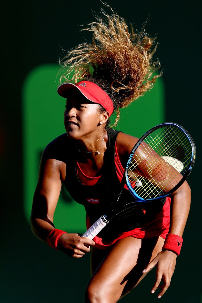 Naomi Osaka holding a racquet during a match 