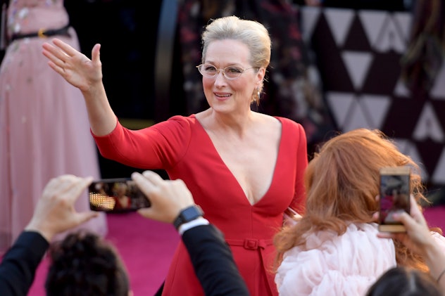 Meryl Streep walking in a red dress