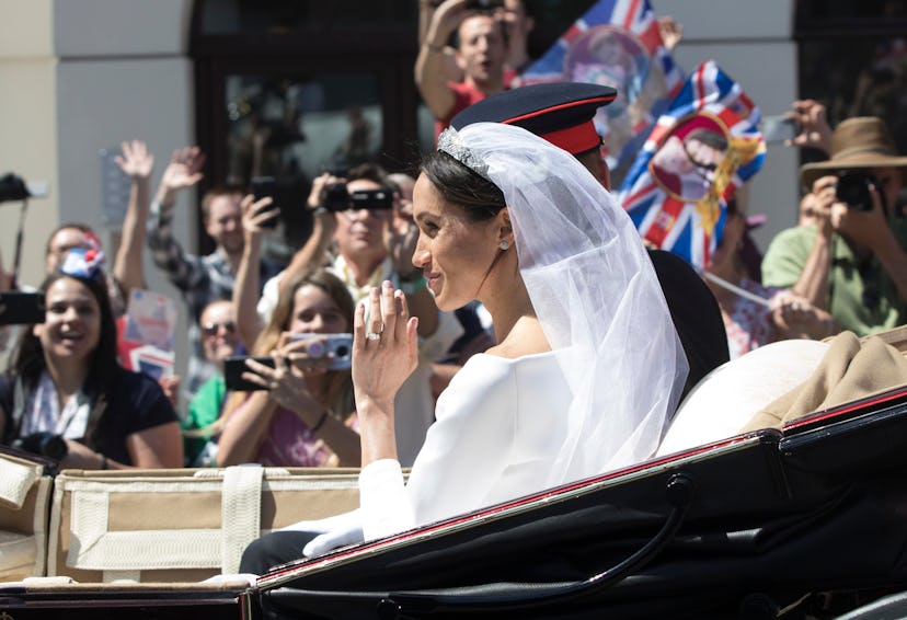 Prince Harry and Meghan Markle in their wedding outfits driving in the car