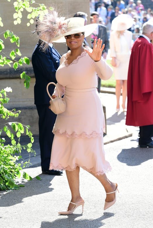 A fancy-dressed woman waving at the camera at the Royal Wedding