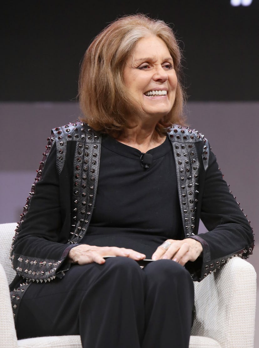 Gloria Steinem sitting in a black outfit
