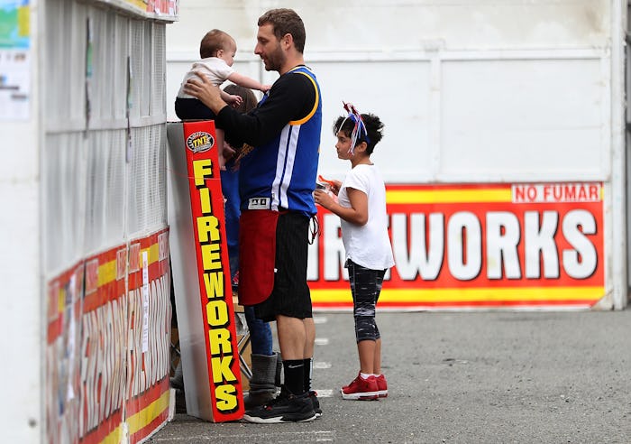 A dad and two children in front of a Fireworks store in New Jersey