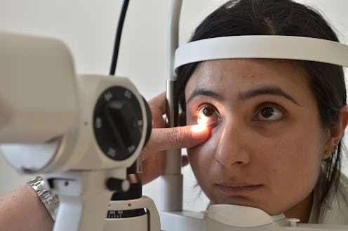 A woman at the ophthalmologist check-up, having her right eye movement examined for ADHD